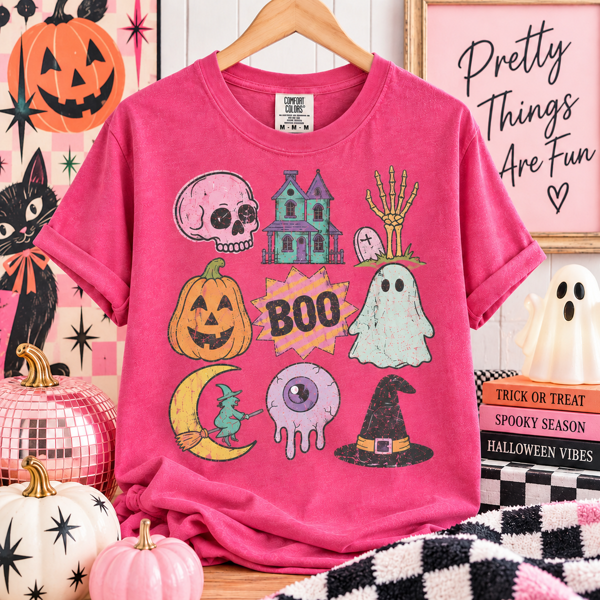Halloween collage graphic on a pink Comfort Colors tee