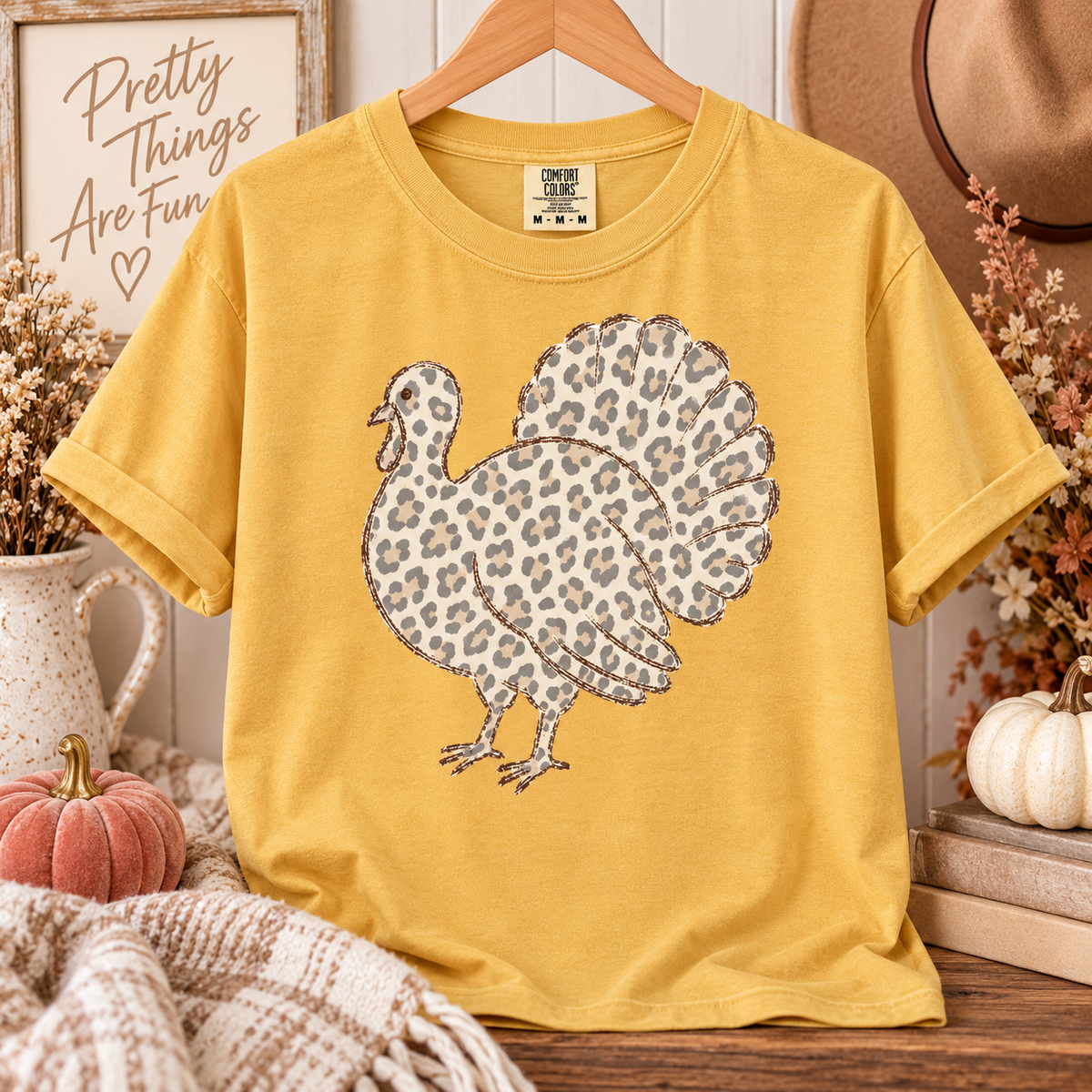 Mustard Comfort Colors tee featuring a turkey silhouette filled with neutral leopard print